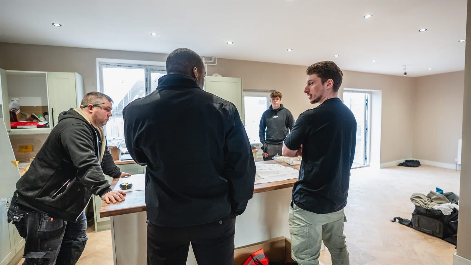 Four of the Northbound team around a kitchen worktop with drawings laid out